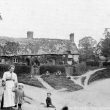 Bishops Tachbrook.  An old cottage and villagers