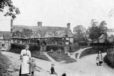 Bishops Tachbrook.  An old cottage and villagers