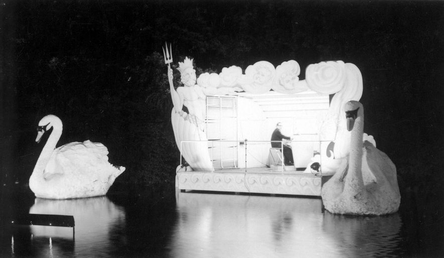 Two giant swans and the lake bandstand at Leamington Lights.  1958 |  IMAGE LOCATION: (Warwickshire County Record Office)