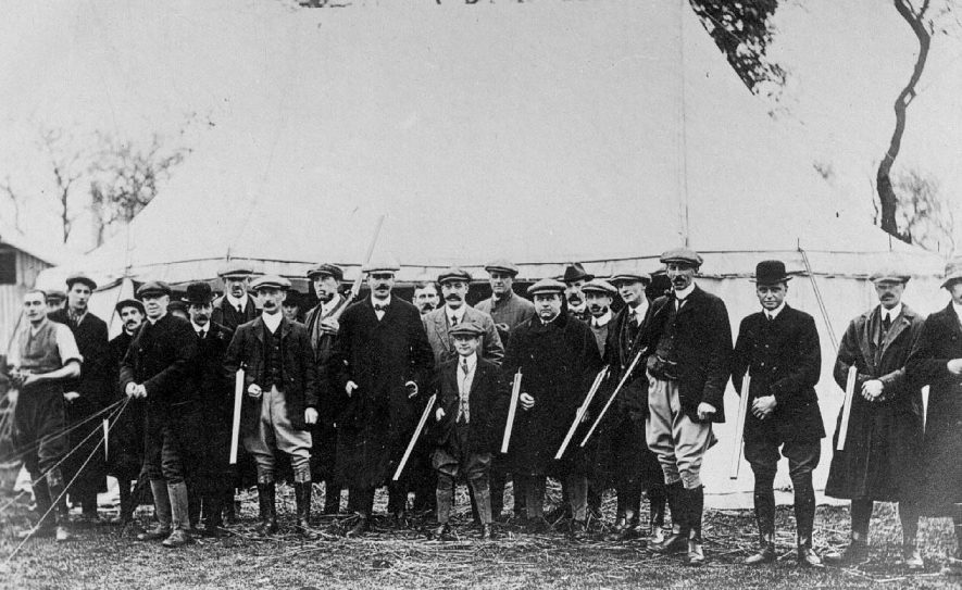 Pigeon shooting party with guns. Marquee behind.  Joe Plant, jockey, standing centre. Barford.  1920s |  IMAGE LOCATION: (Warwickshire County Record Office) PEOPLE IN PHOTO: Plant, Joe, Plant as a surname