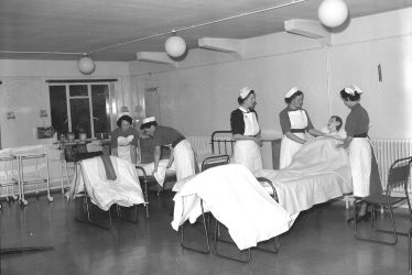 Leamington Spa.  Nurses making beds
