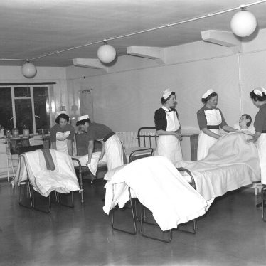 Leamington Spa.  Nurses making beds