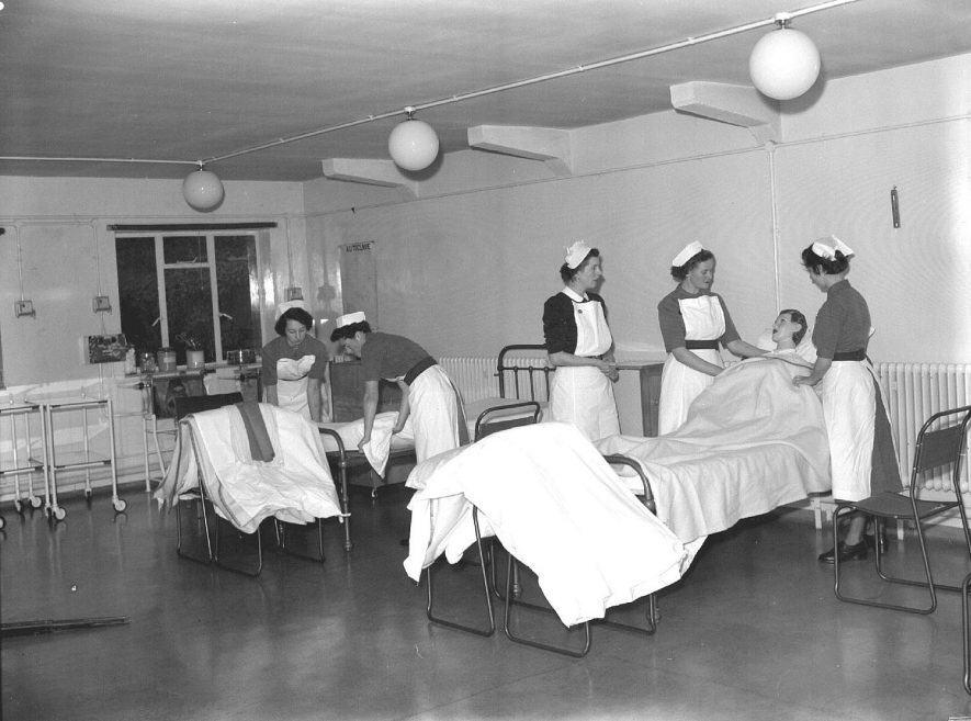 Nurses' Home, 12 St Mary's Road, interior with nurses practising bed-making, Leamington Spa.  23rd September 1954 |  IMAGE LOCATION: (Warwickshire County Record Office)