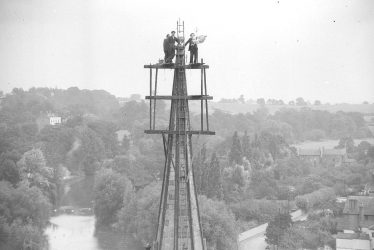 Leamington Spa.  Men erecting weathercock