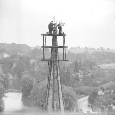 Leamington Spa.  Men erecting weathercock