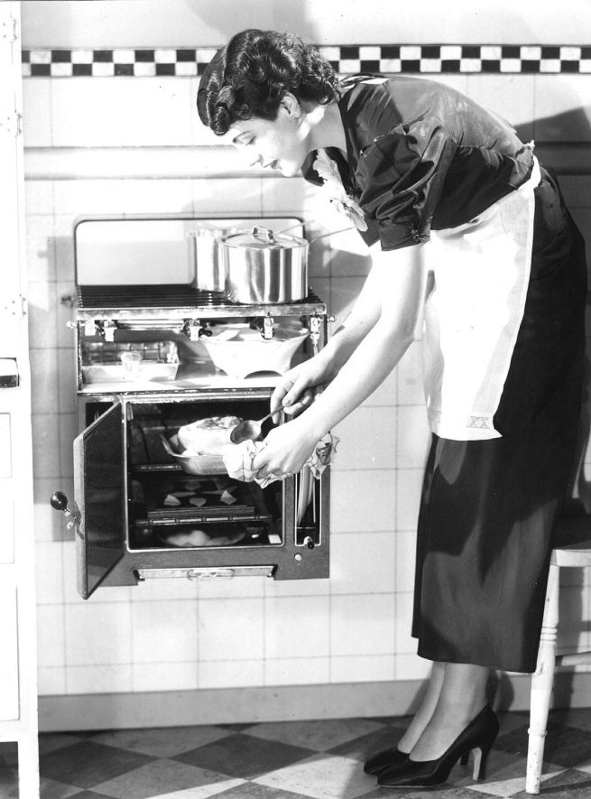 Cookery demonstration of a wall mounted cooker.  1936 |  IMAGE LOCATION: (Warwickshire County Record Office)