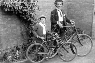 Leamington Spa.  A man and a boy with bicycles