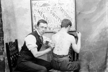 Leamington Spa.  Tattooist at work