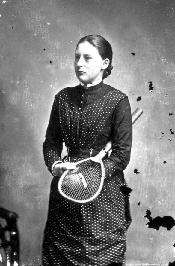 Ms Chambers posing holding a tennis racquet.  1879 |  IMAGE LOCATION: (Warwickshire County Record Office) PEOPLE IN PHOTO: Chambers as a surname