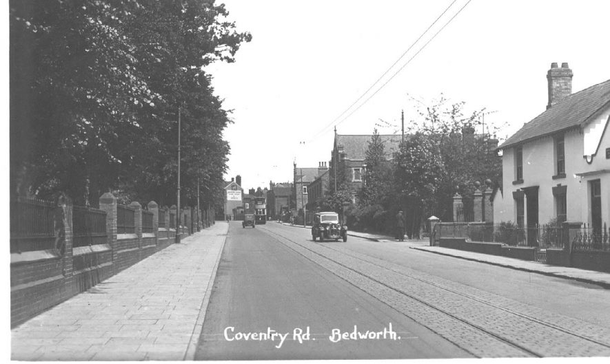 A view of Coventry Road showing two motor cars, a tramcar and rails, Bedworth.  1930s |  IMAGE LOCATION: (Warwickshire County Record Office)