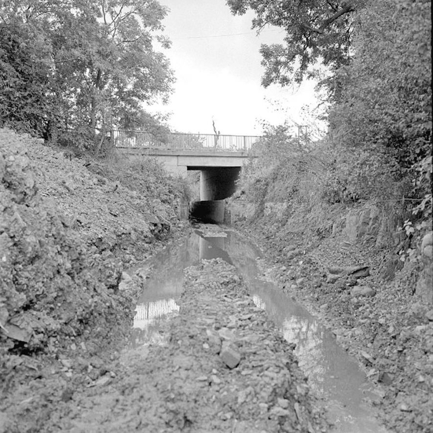 Griff Hollows, when the canal was being filled in and pipes laid to take water from nearby land.  This is the view from Quarry Side, looking along the bed of the canal.  1979 |  IMAGE LOCATION: (Warwickshire County Record Office)