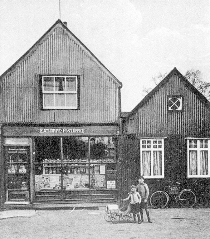 Eathorpe stores and post office with two boys and their toy cart in front.  1910s |  IMAGE LOCATION: (Leamington Library)