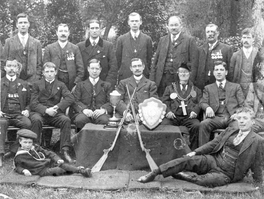 Black Horse Rifle Club, Prince's Street, Leamington Spa. Group photograph, showing awards and two crossed rifles.  1910s |  IMAGE LOCATION: (Leamington Library)