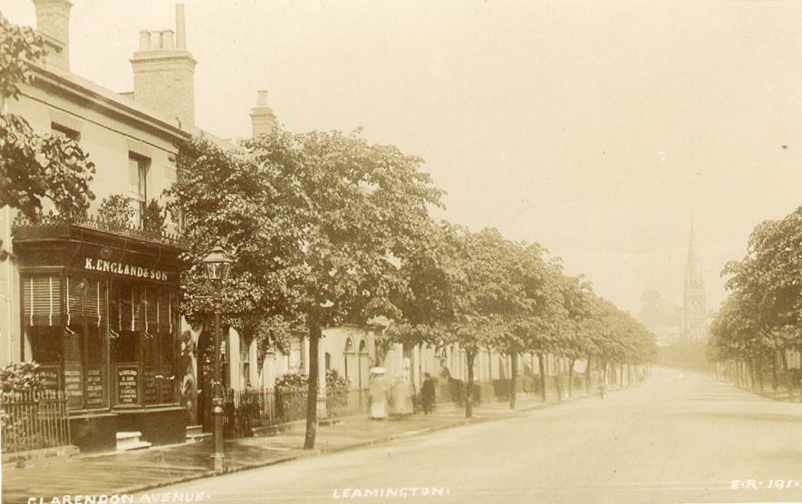 View looking along Clarendon Avenue, Leamington Spa. K. England cabinet makers shop is in the foreground.  1900s |  IMAGE LOCATION: (Leamington Library)