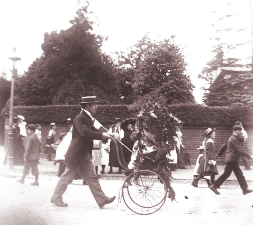 A decorated pram being pushed along the road in Rugby during Queen Victoria's Diamond Jubilee celebrations in 1897. |  IMAGE LOCATION: (Rugby Library)