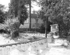 Hillmorton Community Centre with Paddox House in the background and a model railway in the foreground, Rugby.  1961 |  IMAGE LOCATION: (Rugby Library)