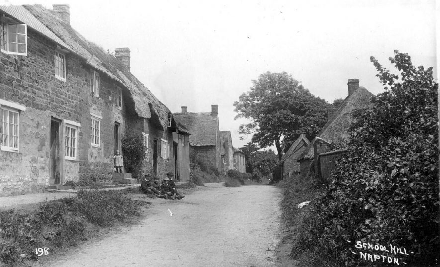 School Hill with group of children outside thatched cottages.  1900s |  IMAGE LOCATION: (Warwickshire County Record Office)