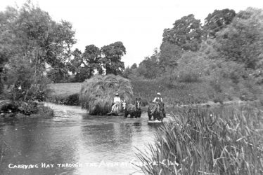 Salford Priors.  Carrying hay through the River Avon