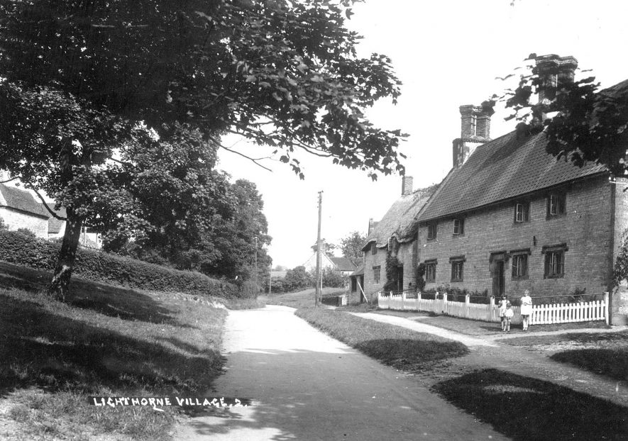 A village road with cottages on the right in Lighthorne.  1930s |  IMAGE LOCATION: (Warwickshire County Record Office)