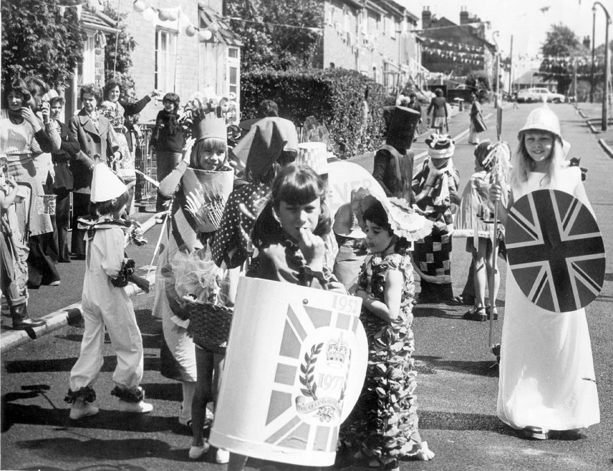 Silver Jubilee celebrations in High View Road, New Cubbington.  Children in fancy dress.  Children: Julie White, Karen Toozer, Lyn Walters, Karen Walters.  Adults: left-right. Lynne Thomas, Janet Robinson, Pat Collins & her mother, Maureen Mannen,  Roger White, Carole Butler.  1977 |  IMAGE LOCATION: (Warwickshire County Record Office) PEOPLE IN PHOTO: White, Roger, White, Julie, White as a surname, Walters, Lynn, Walters, Karen, Walters as a surname, Toozer, Karen, Toozer as a surname, Thomas, Lynne, Thomas as a surname, Robinson, Janet, Robinson as a surname, Mannen, Maureen, Mannen as a surname, Collins, Pat, Collins as a surname, Butler, Carole, Butler as a surname