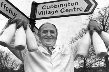 Cubbington.  Milkman under village signpost