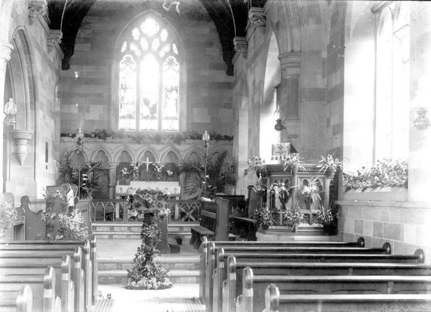 Interior of St Andrew's church, Temple Grafton, decorated for Easter.  1900s |  IMAGE LOCATION: (Warwickshire County Record Office)