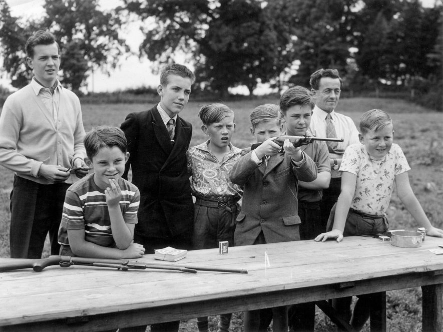 Men and boys with air rifles. From left to right - Patrick Midgley, Michael Rose, John Carrol, Ken Evans, Ray Hawker, Chris Rose, Bill Smith, Alun Jones. Offchurch.  1960s |  IMAGE LOCATION: (Warwickshire County Record Office) PEOPLE IN PHOTO: Smith, Bill, Smith as a surname, Rose, Michael, Rose, Chris, Rose as a surname, Midgley, Patrick, Midgley as a surname, Jones, Alun, Jones as a surname, Hawker, Ray, Hawker as a surname, Evans, Ken, Evans as a surname, Carrol, John, Carrol as a surname