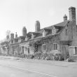 Arrow.  A row of cottages
