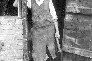 Exhall, nr Alcester.  Mr Mason outside The Forge