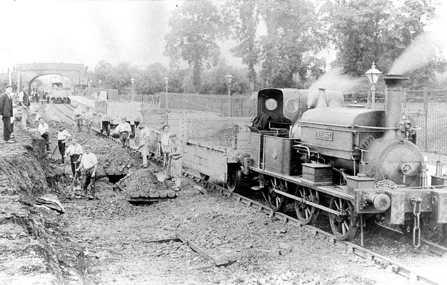 Workmen working on the railway at Wilmcote.  A steam engine named 