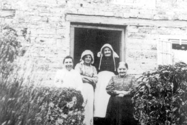 Lighthorne.  Group of women in doorway of a cottage
