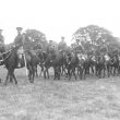 Warwick.  Troop of mounted cavalry in a park