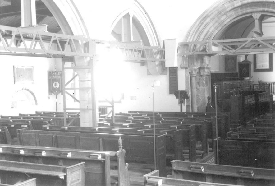 Ansley church interior. The supporting girders were added in 1960 by the National Coal Board to prevent subsidence while they mined underneath. They were removed in 1968.  1960s |  IMAGE LOCATION: (Warwickshire County Record Office)