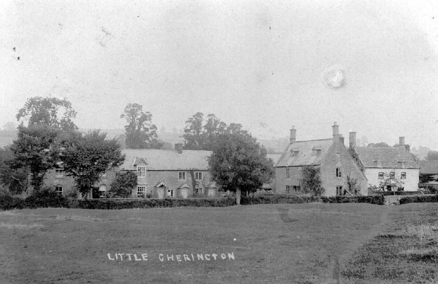 Little Cherington. Field with road beyond and cottages.  1900s |  IMAGE LOCATION: (Warwickshire County Record Office)