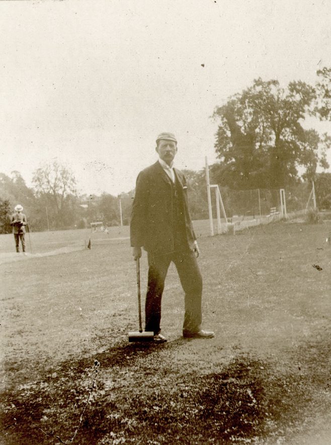 A man standing in the grounds of Warwick boat club.  1910s |  IMAGE LOCATION: (Warwickshire County Record Office)