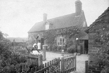 Cubbington.  Mrs Wells in front of her cottage