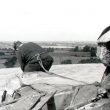 Chesterton.  Man working on windmill roof