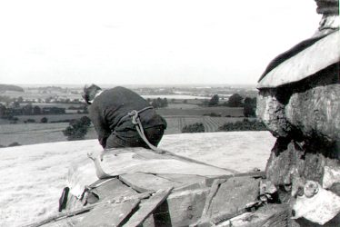 Chesterton.  Man working on windmill roof