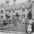 Combrook.  Women and children in front of cottages