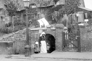 Cubbington.  Mrs Wells at the village pump