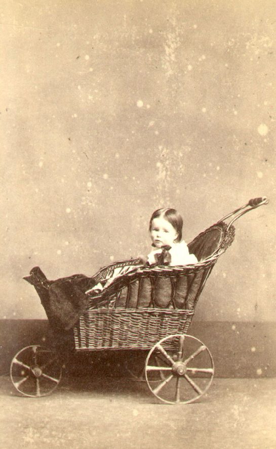 Sarah Beatrice Lowe in her perambulator. Daughter of William Bevington Lowe and Rachel J. Lowe, born 5th March 1864.  Taken 5th May 1865 and sent to her aunt, Sarah Gibbins (nee Lowe).  Ettington.  1865 |  IMAGE LOCATION: (Warwickshire County Record Office) PEOPLE IN PHOTO: Lowe, Sarah Beatrice, Lowe as a surname