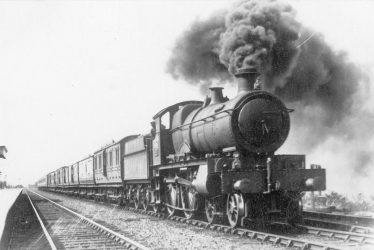 Fenny Compton.  Steam train passing through the station