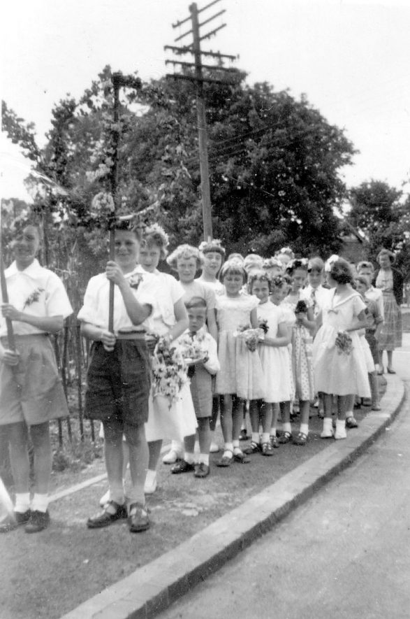 Group of children parading in Gaydon. They are dressed up possibly for May Day celebrations.  1959 |  IMAGE LOCATION: (Warwickshire County Record Office)