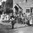 Compton Wynyates.  Young people playing leapfrog