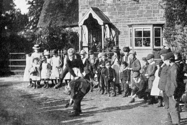 Compton Wynyates.  Young people playing leapfrog