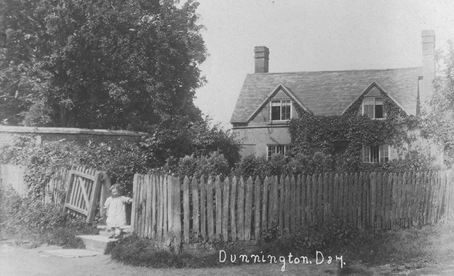 A cottage in Dunnington with a child standing in gateway.  1900s |  IMAGE LOCATION: (Warwickshire County Record Office)