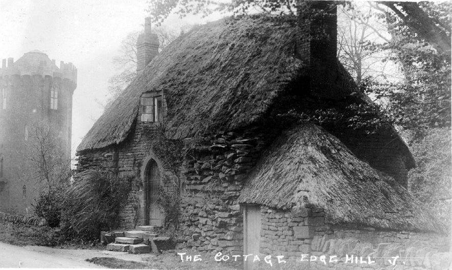 Thatched stone cottage with arched doorway, standing near to stone tower, Edgehill.  1900s |  IMAGE LOCATION: (Warwickshire County Record Office)