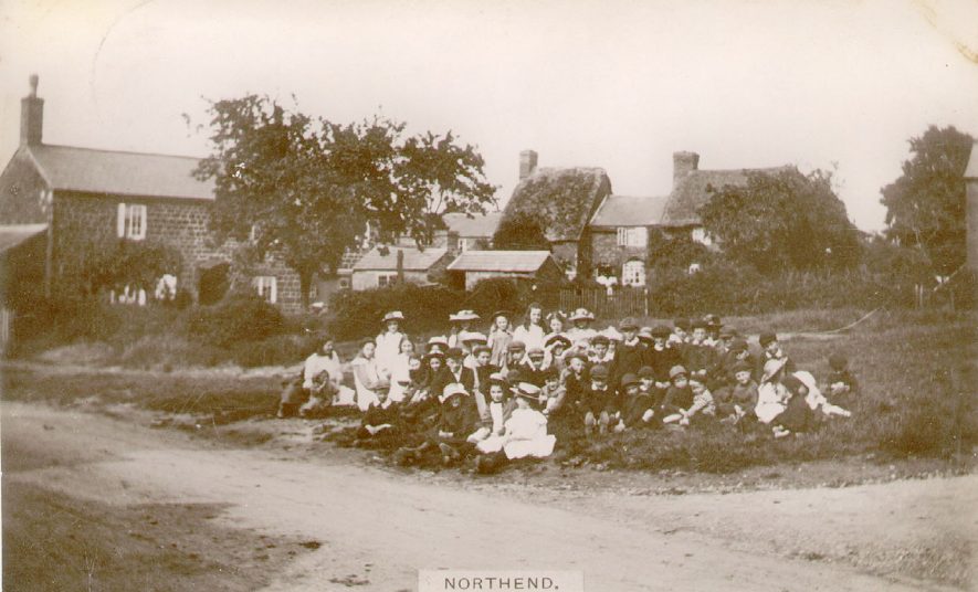 Group of children sitting on The Green at Northend.  1910s |  IMAGE LOCATION: (Warwickshire County Record Office)
