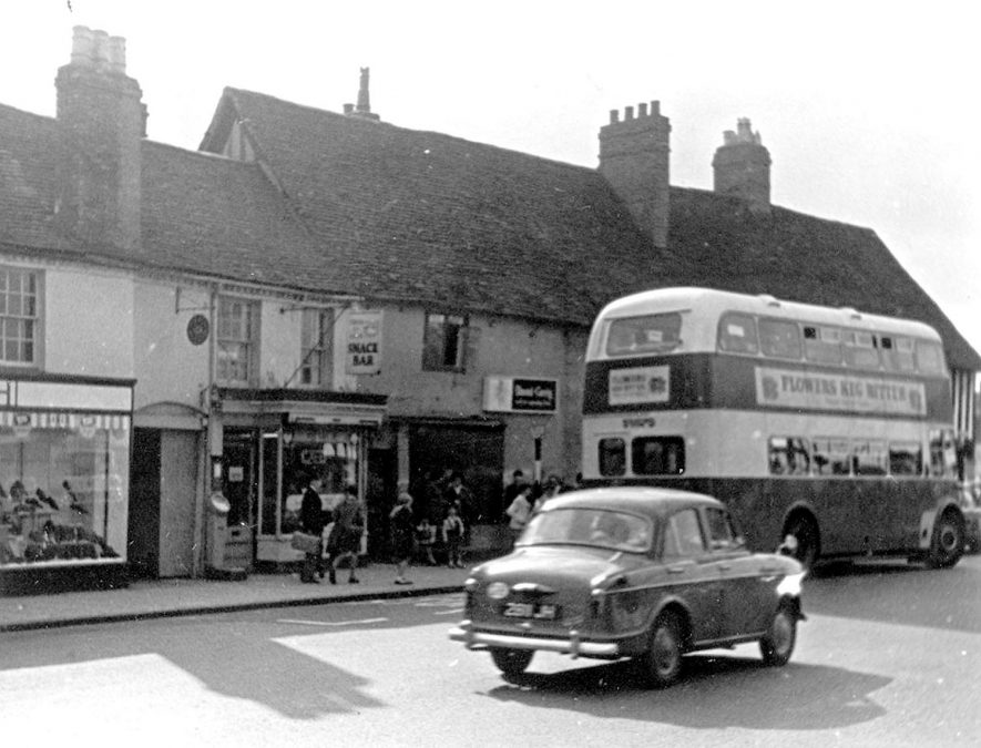 Wood Street, showing old shops, car and 'bus, Stratford upon Avon.  c.1961 |  IMAGE LOCATION: (Warwickshire County Record Office) IMAGE DATE: (c.1961)