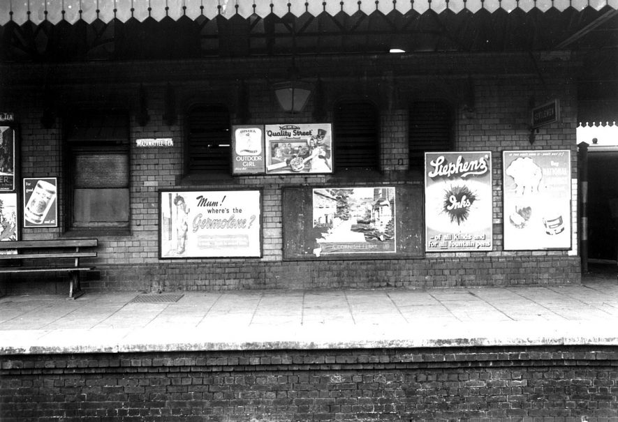 The railway station and advertising billboards, Stratford upon Avon.  1954 |  IMAGE LOCATION: (Warwickshire County Record Office)